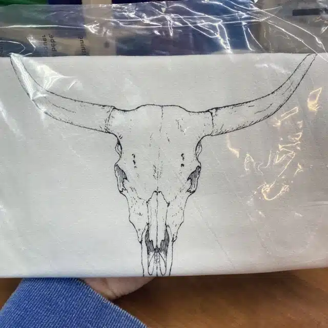 white cotton tea towel with a cow skull