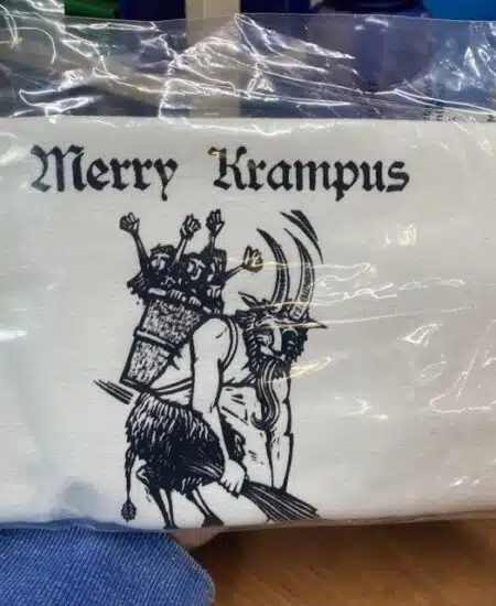 cotton tea towel with a vintage German Krampus that says merry cramps