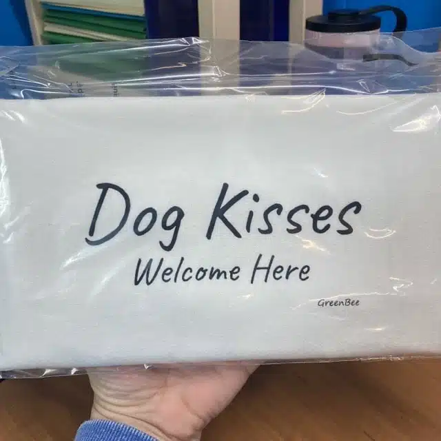 tea towel that says dog kisses welcome here
