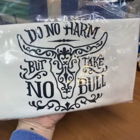 cotton tea towel that says do no harm but take no bull with a decorative cow skull slightly flawed kitchen tea towel
