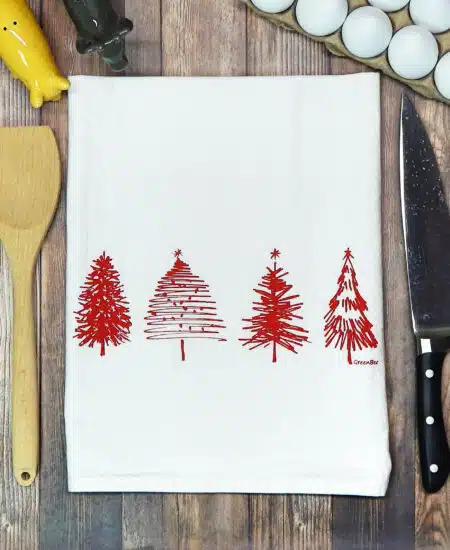 cotton tea towel with four hand drawn Christmas trees printed in red ink